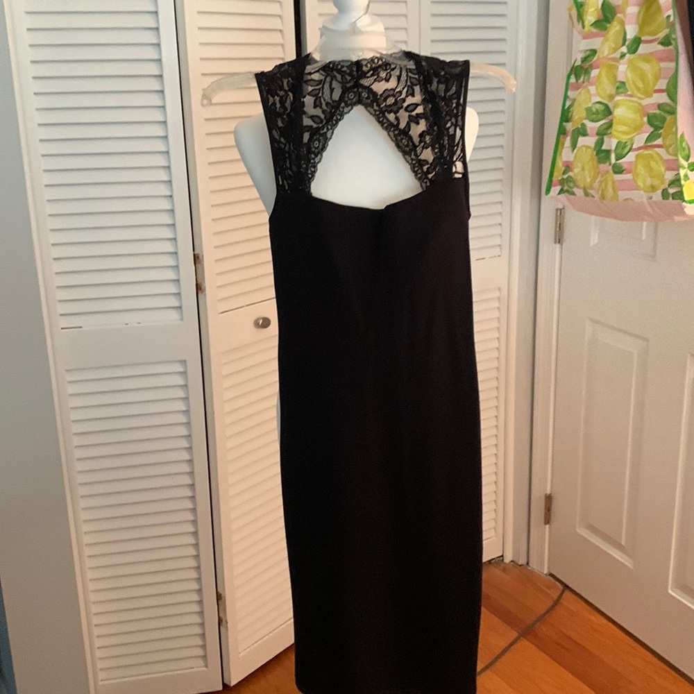 Black cocktail dress with lace straps and partial open back